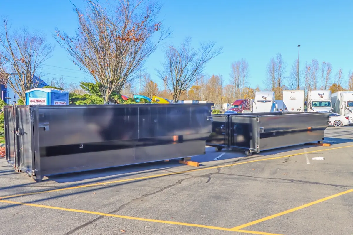 Professional dumpster rental service with roll-off container on residential driveway in Berwick